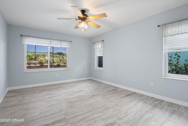 empty room featuring ceiling fan and light hardwood / wood-style flooring