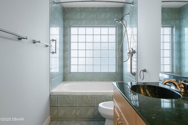 full bathroom featuring tile patterned floors, vanity, toilet, and tiled shower / bath combo