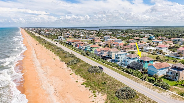 bird's eye view featuring a water view and a beach view