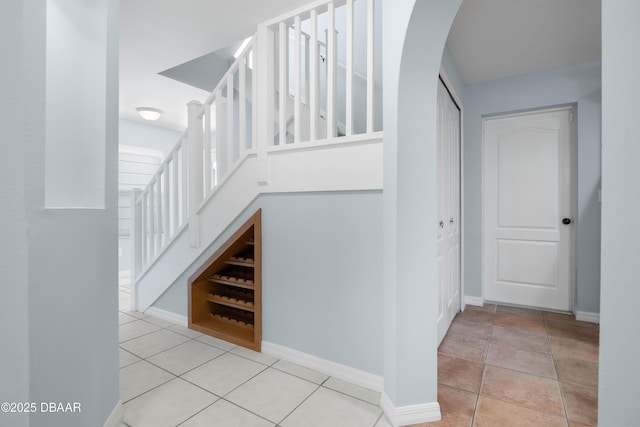 stairs featuring tile patterned flooring