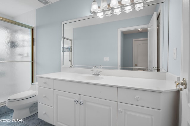 bathroom with tile patterned floors, vanity, toilet, and walk in shower