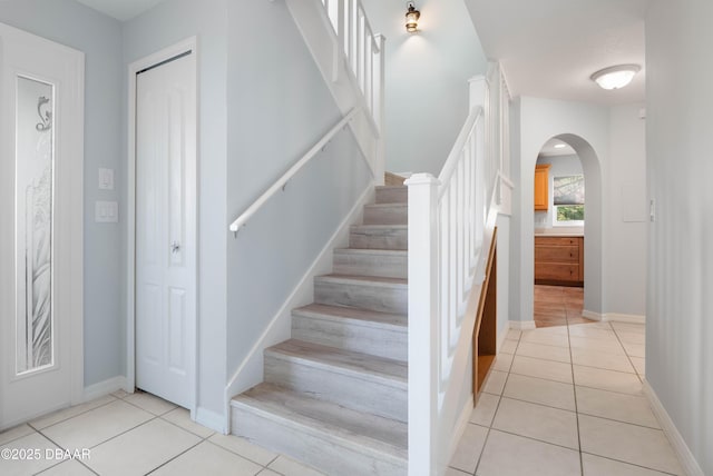 stairs featuring tile patterned floors