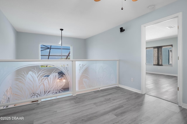 unfurnished room featuring ceiling fan and light wood-type flooring