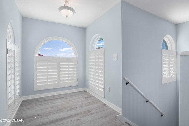 unfurnished room with light hardwood / wood-style floors and a healthy amount of sunlight