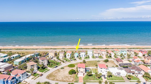 birds eye view of property featuring a view of the beach and a water view