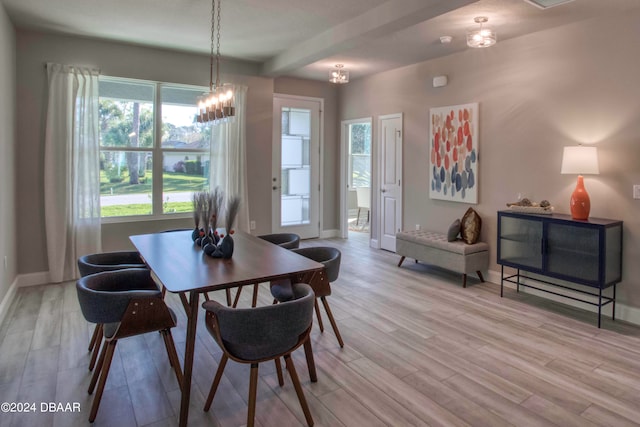 dining area with an inviting chandelier, beam ceiling, and light wood-type flooring