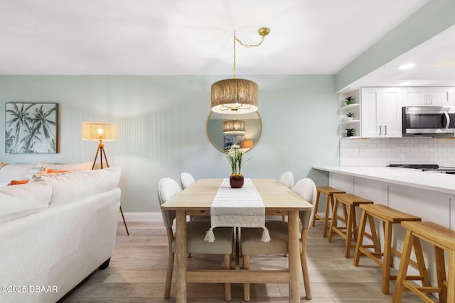 dining area featuring light wood-type flooring