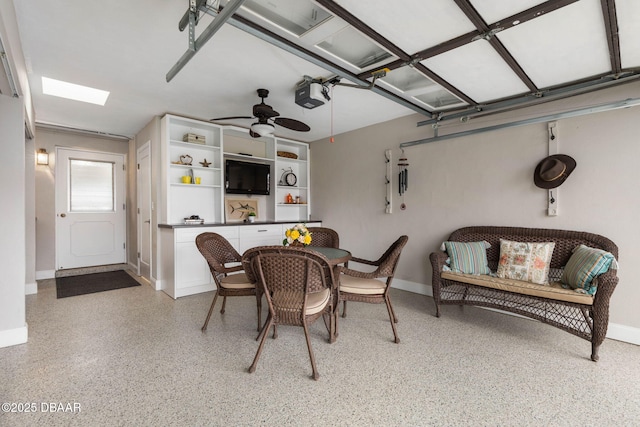 dining room with a skylight and ceiling fan