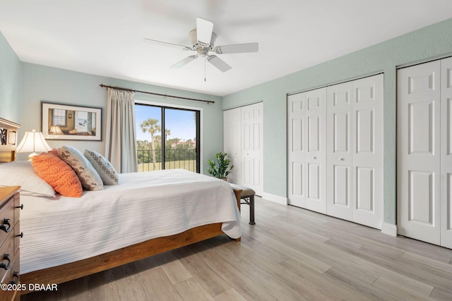 bedroom featuring two closets, ceiling fan, light wood-type flooring, and access to exterior