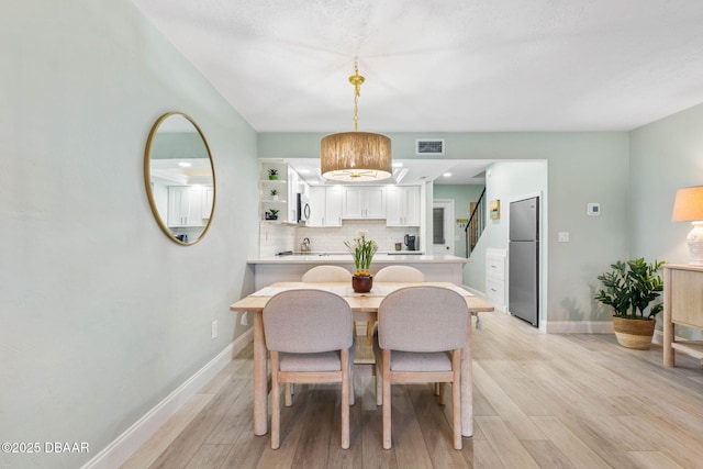 dining space featuring light wood-type flooring