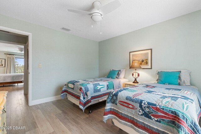 bedroom with ceiling fan and light hardwood / wood-style floors