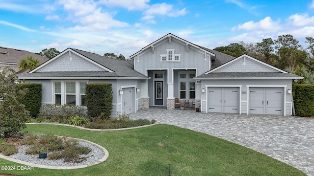 view of front of home featuring a garage and a front lawn