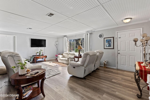 living room with hardwood / wood-style flooring, ornamental molding, and wooden ceiling