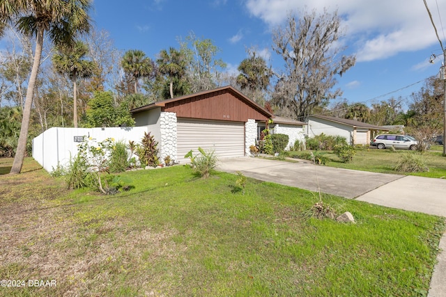 view of front of house with a garage and a front lawn