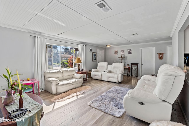 living room with wood-type flooring and ornamental molding