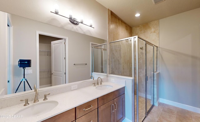 bathroom featuring tile patterned flooring, vanity, and an enclosed shower