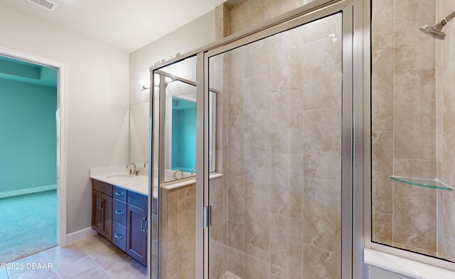 bathroom with tile patterned floors, vanity, and an enclosed shower