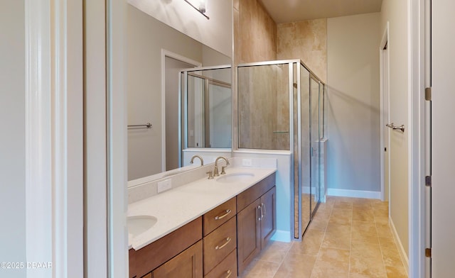 bathroom with vanity, an enclosed shower, and tile patterned flooring