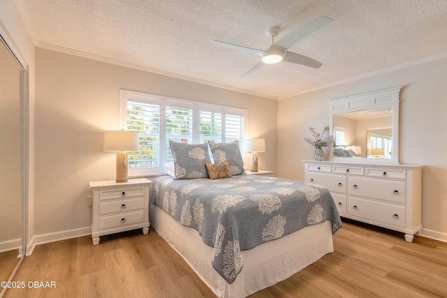 bedroom featuring crown molding, light wood-type flooring, and a textured ceiling