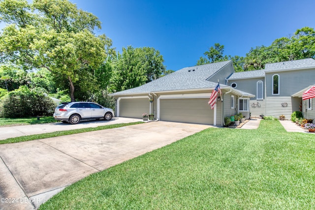 view of front of property with a garage and a front yard