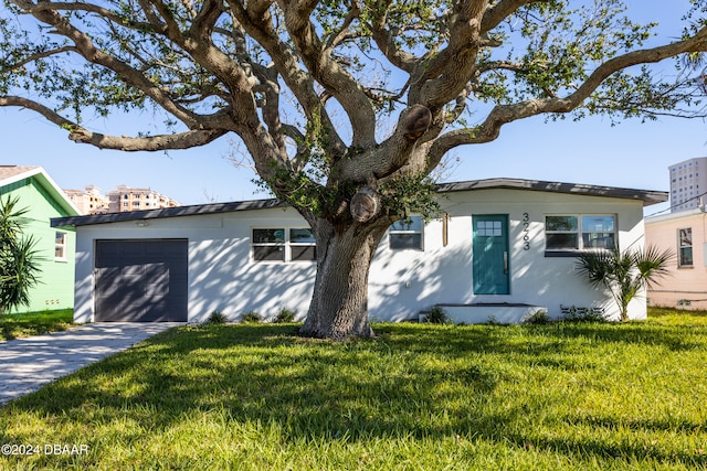 view of front of property with a front lawn and a garage