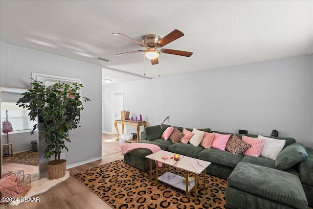 living room with light hardwood / wood-style flooring and ceiling fan