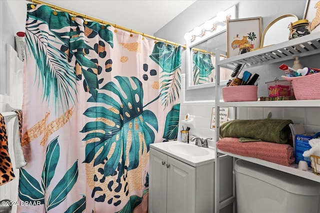 bathroom featuring walk in shower, vanity, and toilet