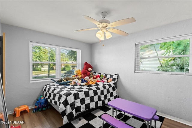 bedroom with ceiling fan and wood-type flooring