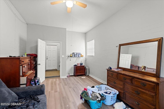 bedroom featuring radiator heating unit, ceiling fan, and light hardwood / wood-style flooring