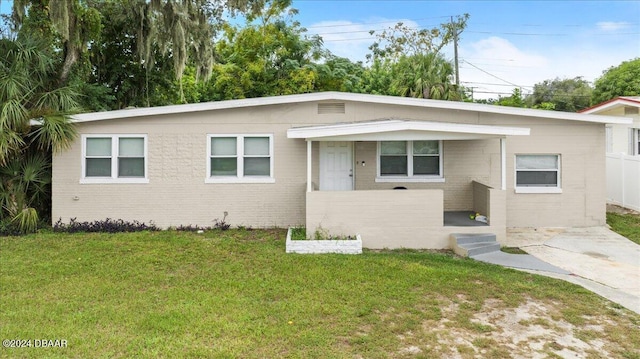 856 Essex Rd, Daytona Beach, FL 32117 - view of front of property with a front yard and brick siding