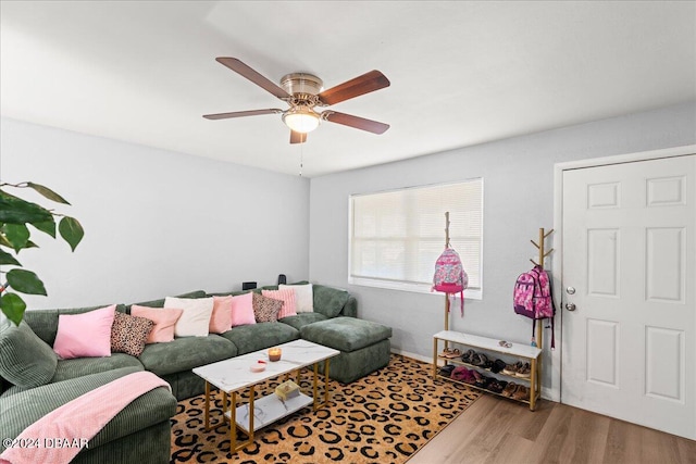 living room featuring hardwood / wood-style floors and ceiling fan