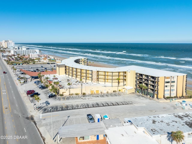 birds eye view of property with a view of the beach and a water view