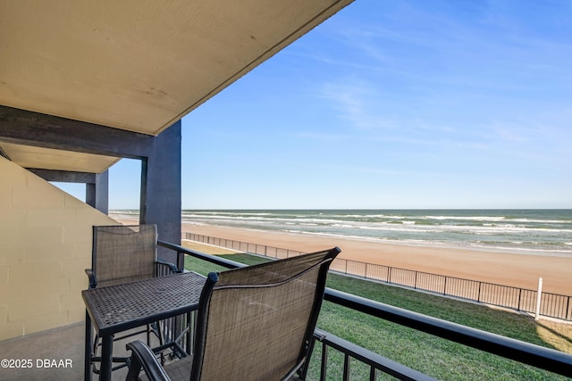 balcony with a beach view and a water view