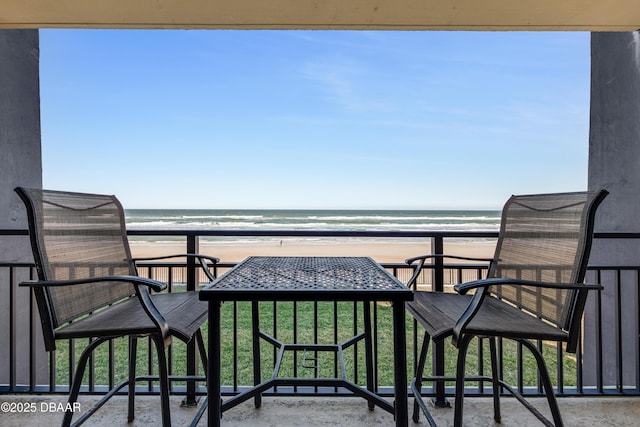 balcony with a beach view and a water view