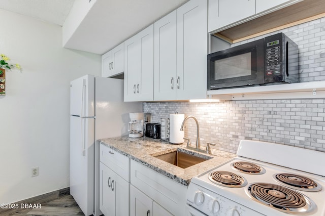 kitchen featuring sink, white cabinetry, light stone counters, white appliances, and decorative backsplash