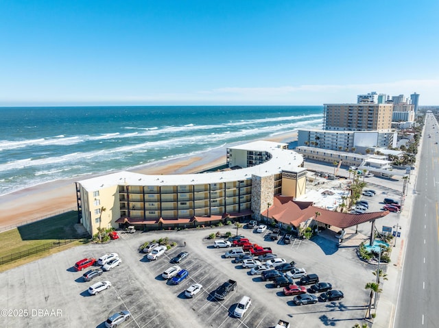 birds eye view of property featuring a beach view and a water view