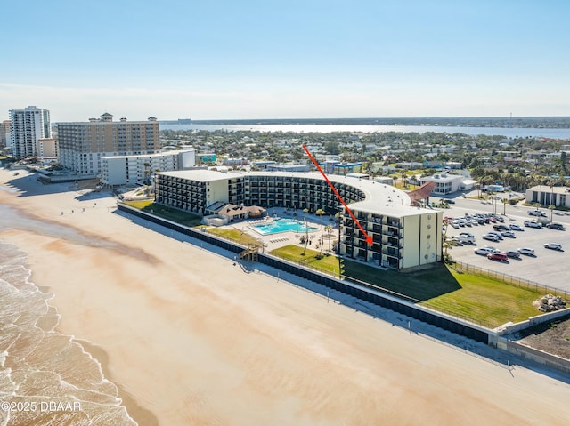 birds eye view of property featuring a beach view and a water view