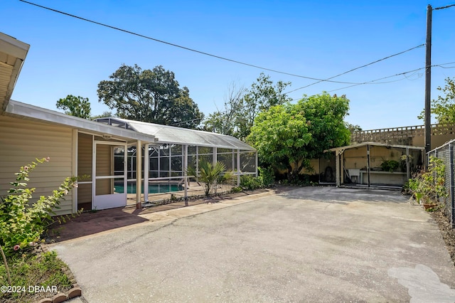 view of patio with glass enclosure