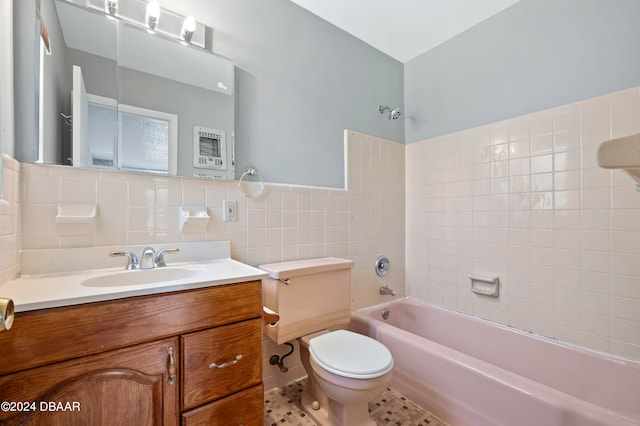 full bathroom featuring tile walls, vanity, tiled shower / bath combo, tile patterned flooring, and toilet