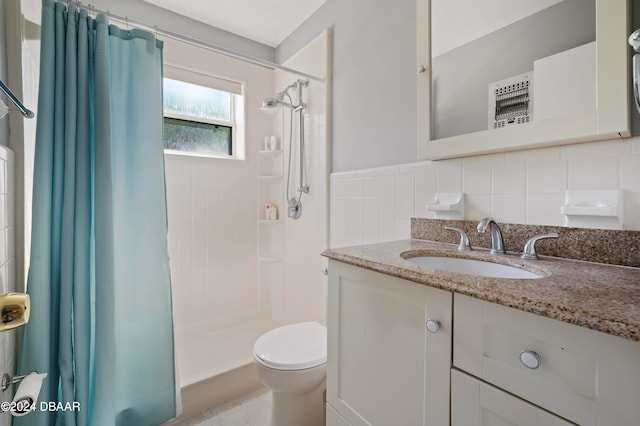 bathroom featuring toilet, vanity, walk in shower, and tile walls