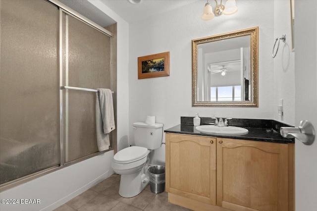 full bathroom featuring toilet, tile patterned floors, shower / bath combination with glass door, ceiling fan, and vanity