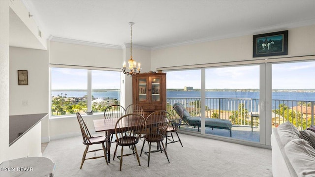 dining space featuring a healthy amount of sunlight and a water view