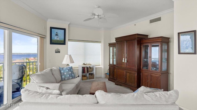 living room featuring ceiling fan, light carpet, and ornamental molding