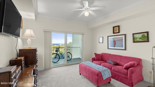 living room featuring ornamental molding, carpet floors, and ceiling fan