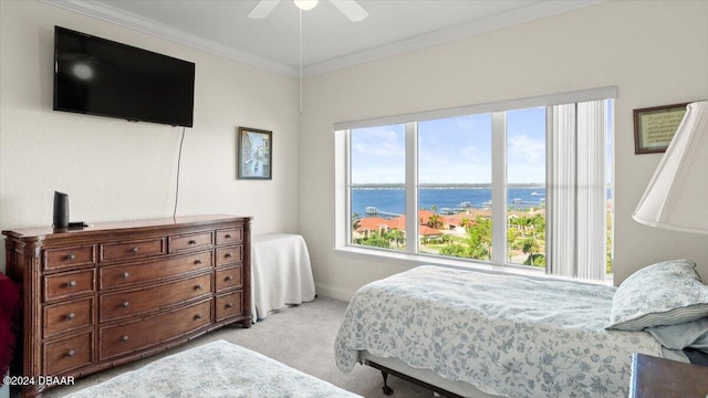 bedroom with ceiling fan, light carpet, and ornamental molding