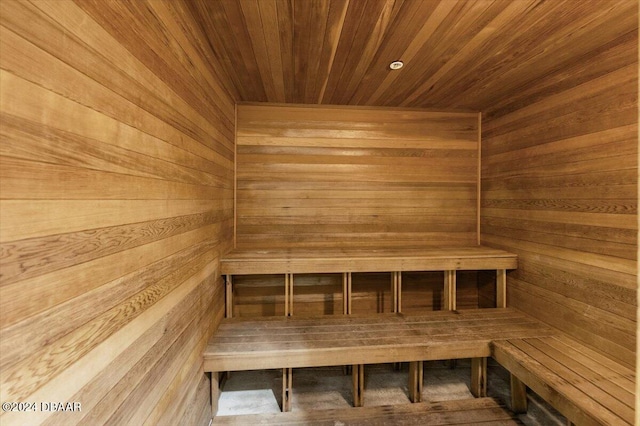 view of sauna featuring hardwood / wood-style floors, wooden walls, and wooden ceiling