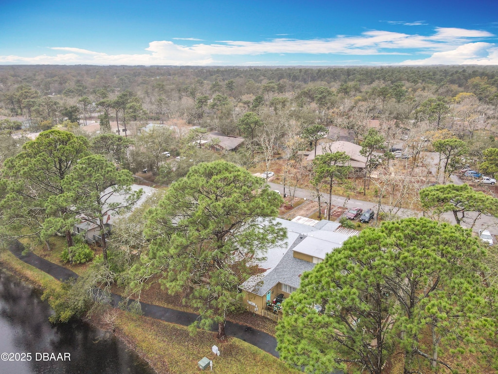 drone / aerial view with a wooded view