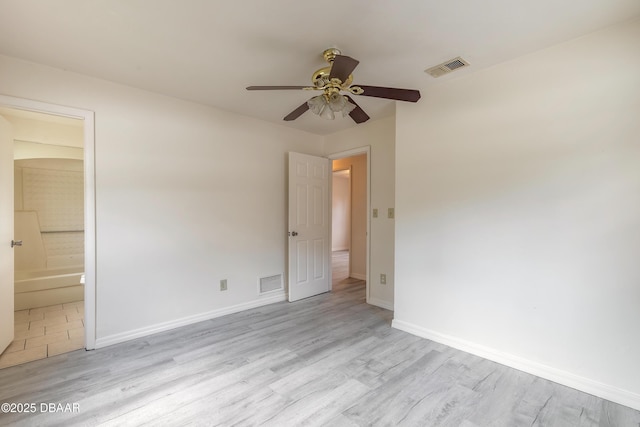 unfurnished bedroom featuring light wood-type flooring, visible vents, and baseboards