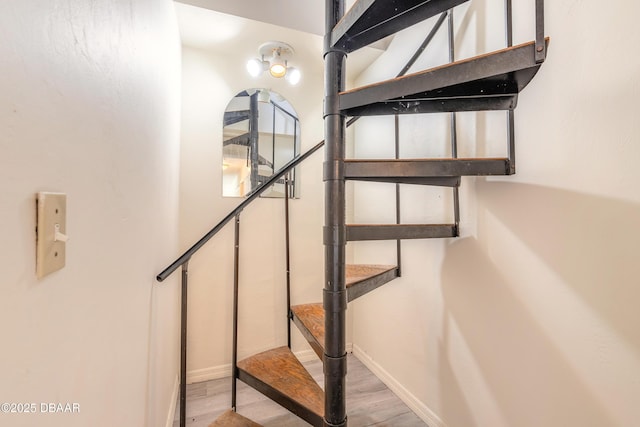 stairs with baseboards and wood finished floors