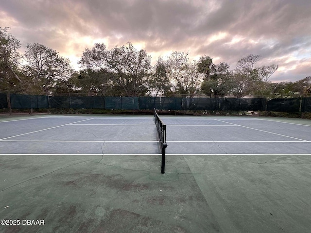 view of tennis court with basketball hoop